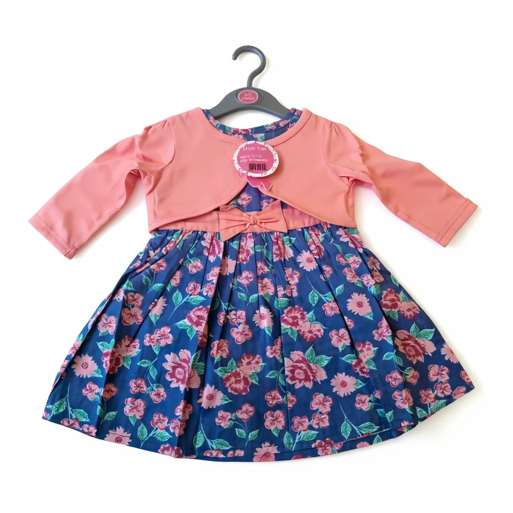 Children's dress with pink jacket on a hanger against a white background