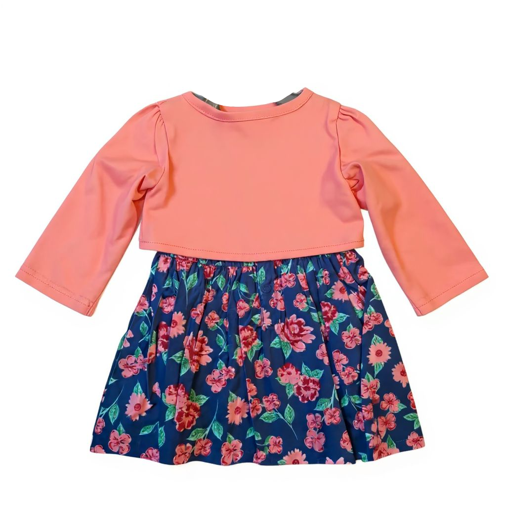 Children's outfit with pink long-sleeve top and floral skirt on a white background