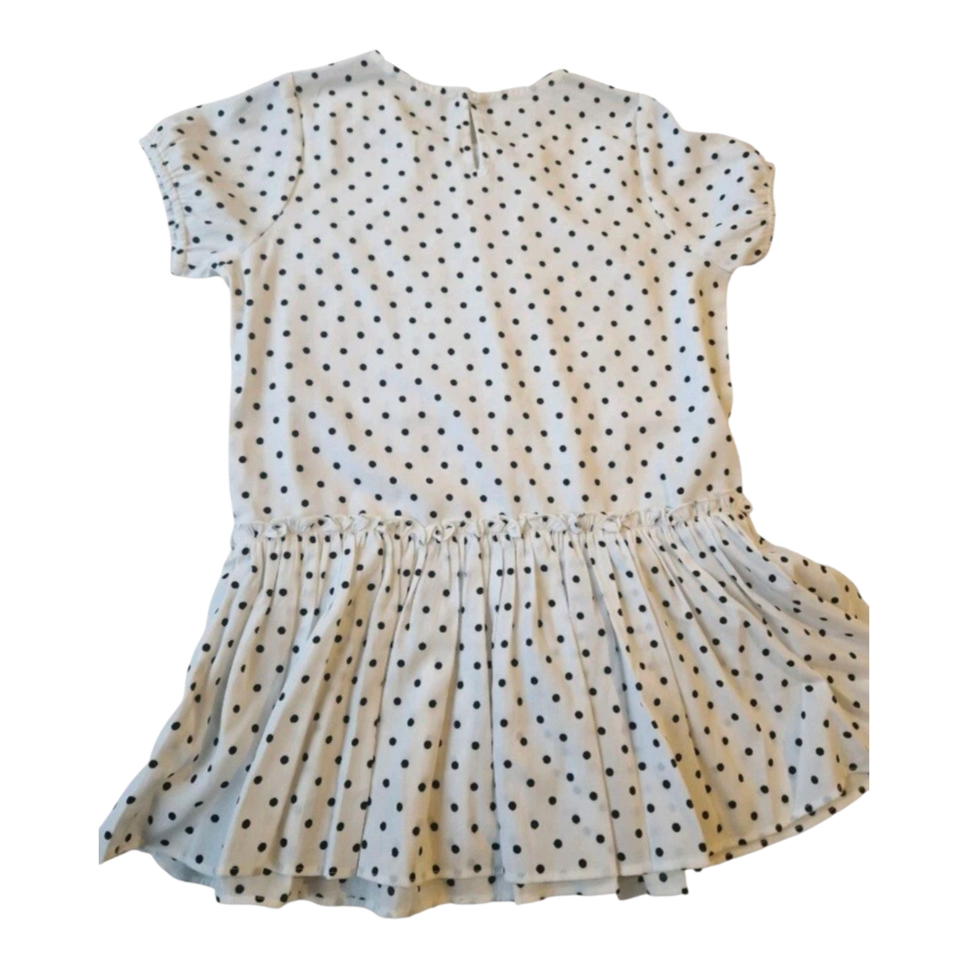 Beige dress with black polka dots on a white background