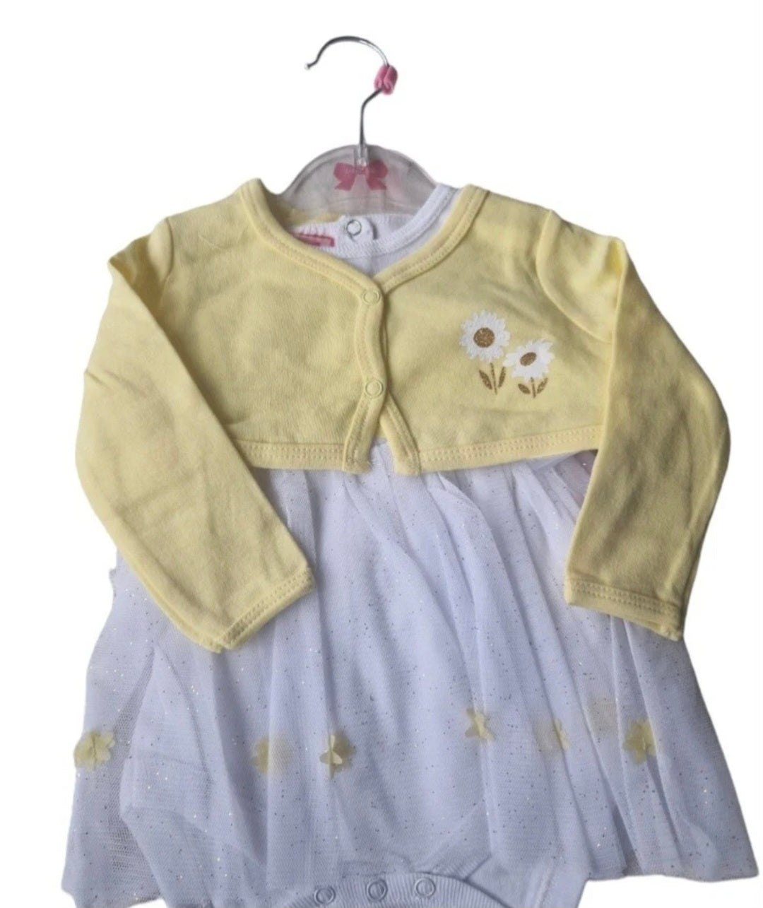 Baby outfit with yellow cardigan and gray onesie on a hanger