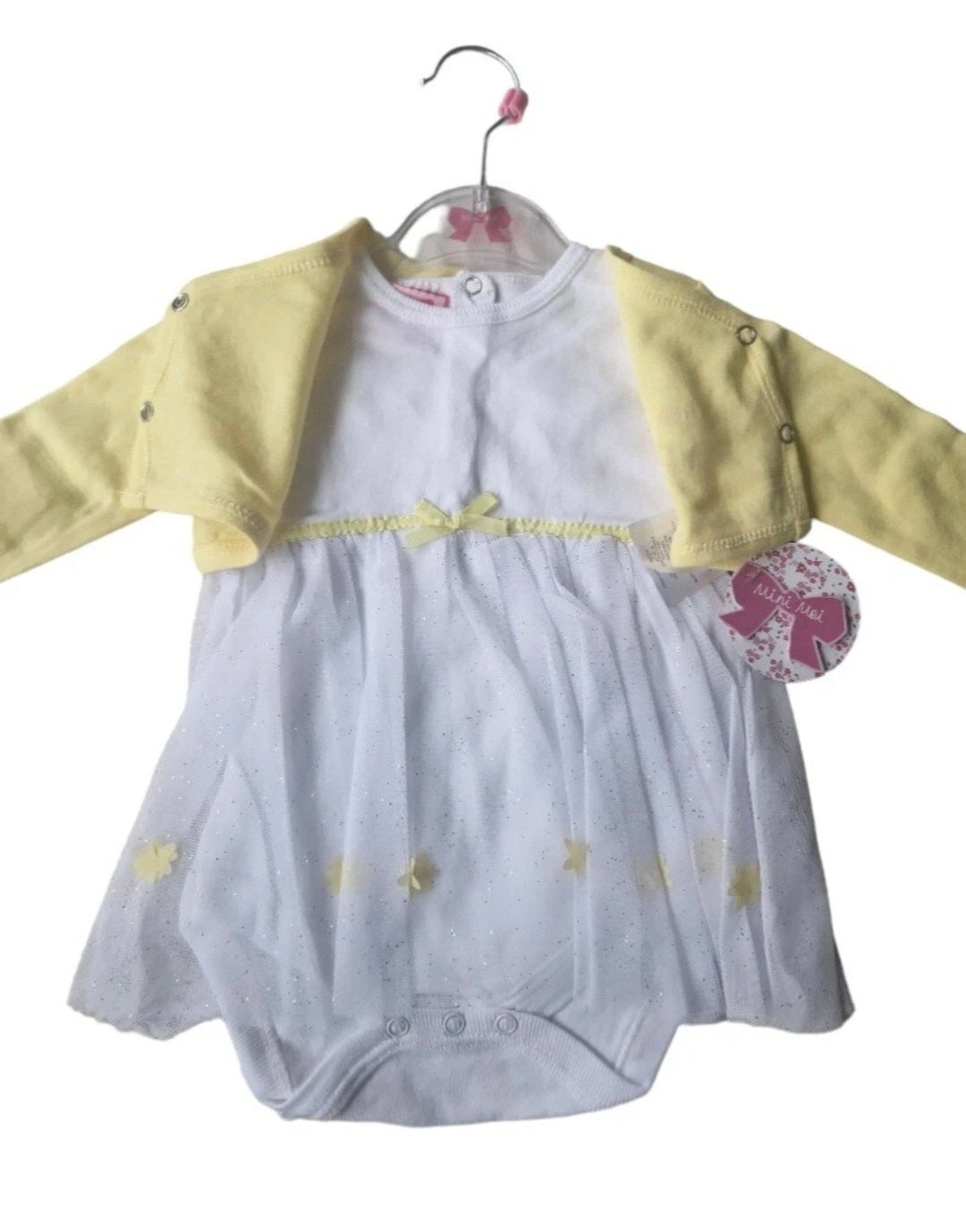 Baby outfit with yellow sleeves and gray body on a hanger against a white background