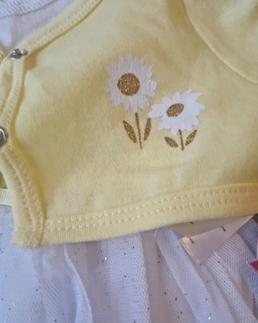 Yellow fabric with embroidered daisies on a white background