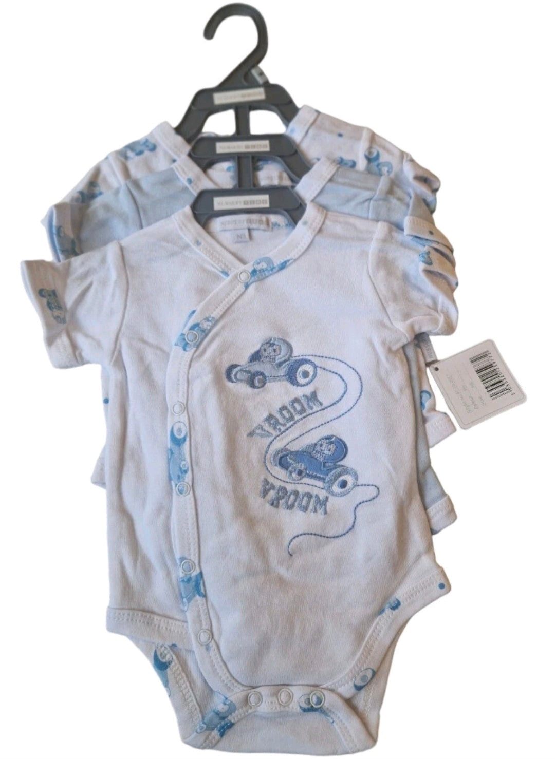 Two baby bodysuits on a hanger with a visible brand tag, featuring blue graphics and text.