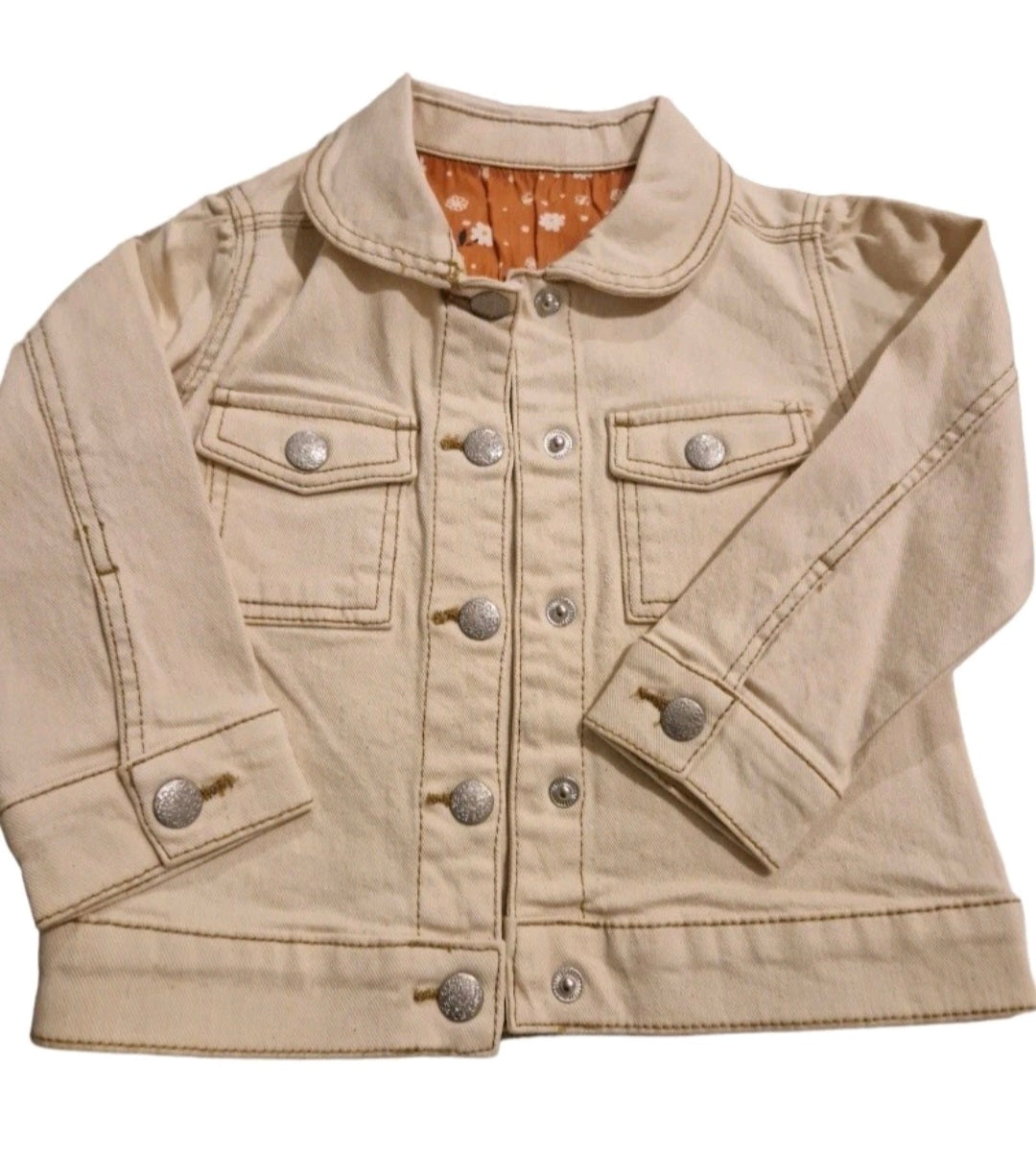 Beige denim jacket with button details on a white background
