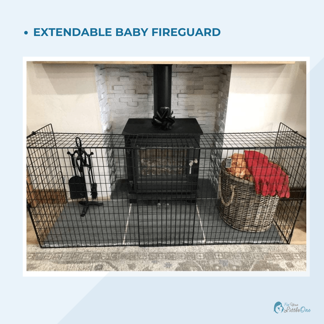 Extendable baby fireguard in front of a fireplace with a basket and tools on a light blue background.