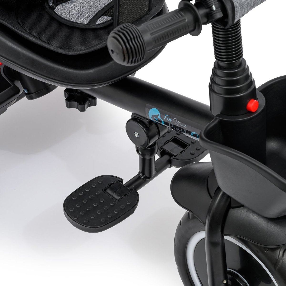 Close-up of a black children's tricycle with cup holder and footrest on a white background