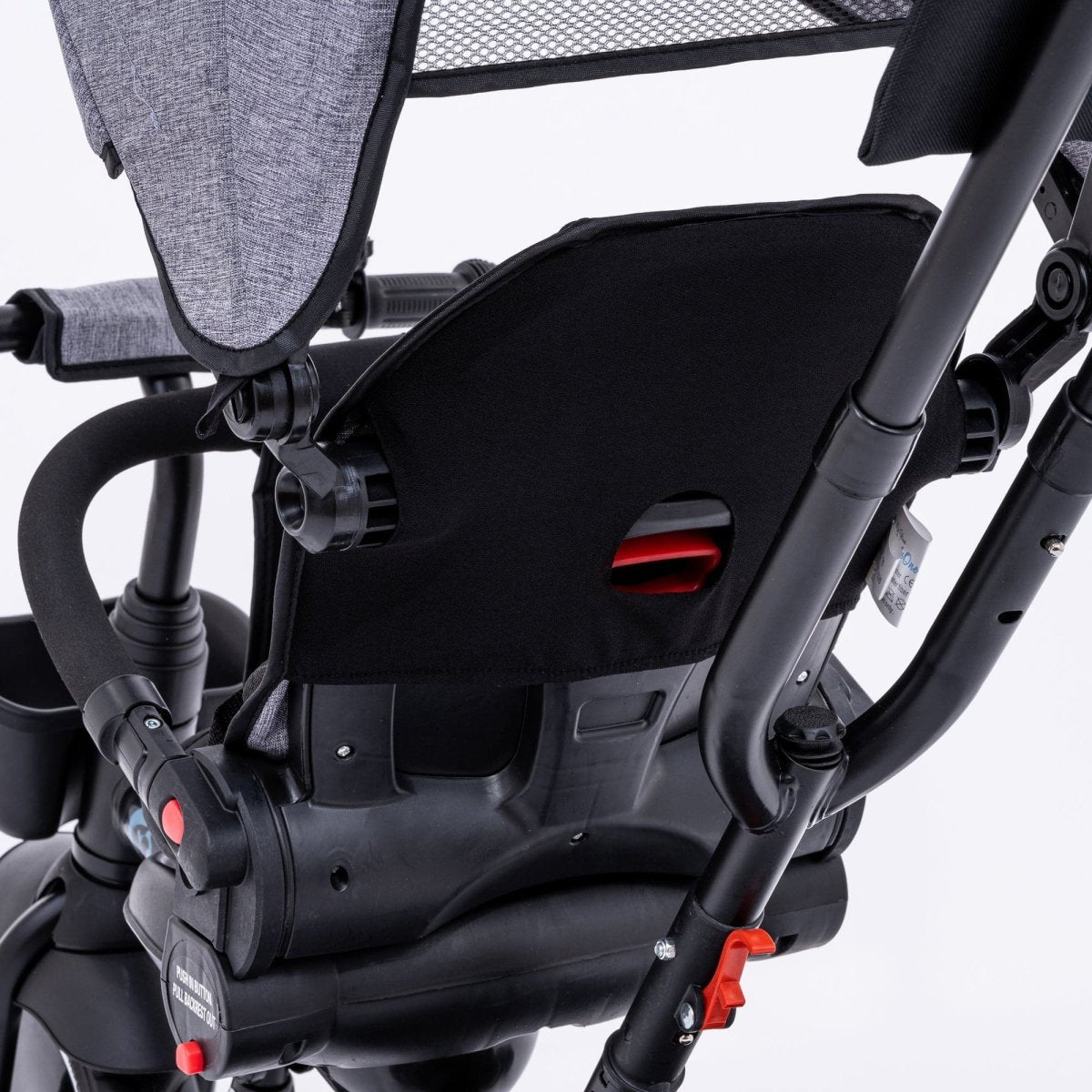 Close-up of a black car seat attached to a stroller with gray canopy on a white background