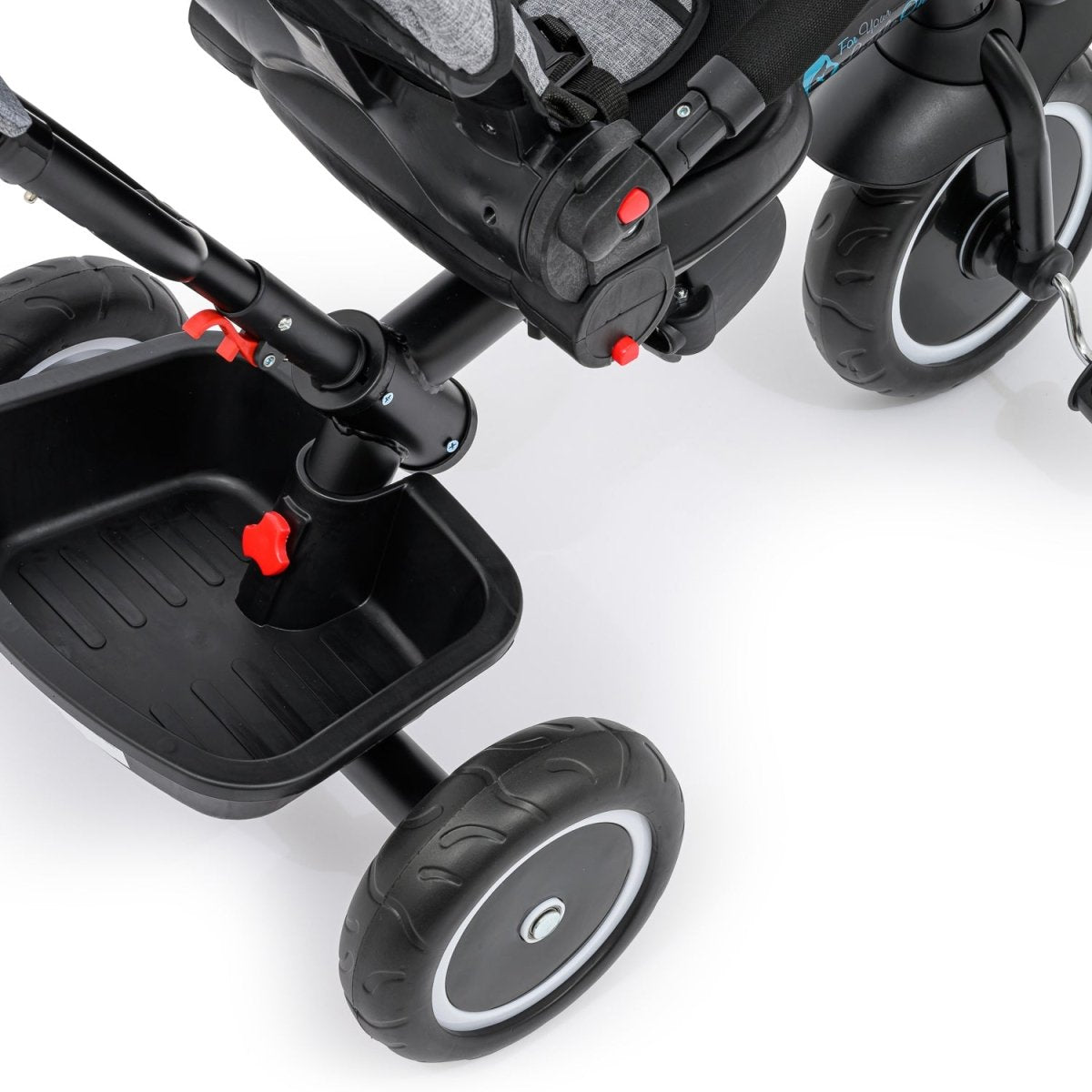 Close-up of a black stroller with wheels and handlebars on a white background