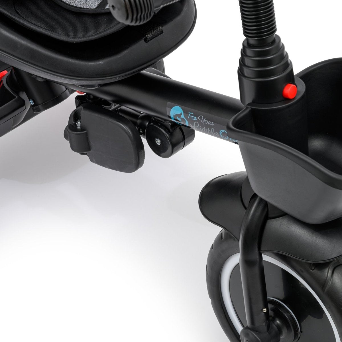 Close-up of a black stroller with cup holder and handlebar attachments on a white background