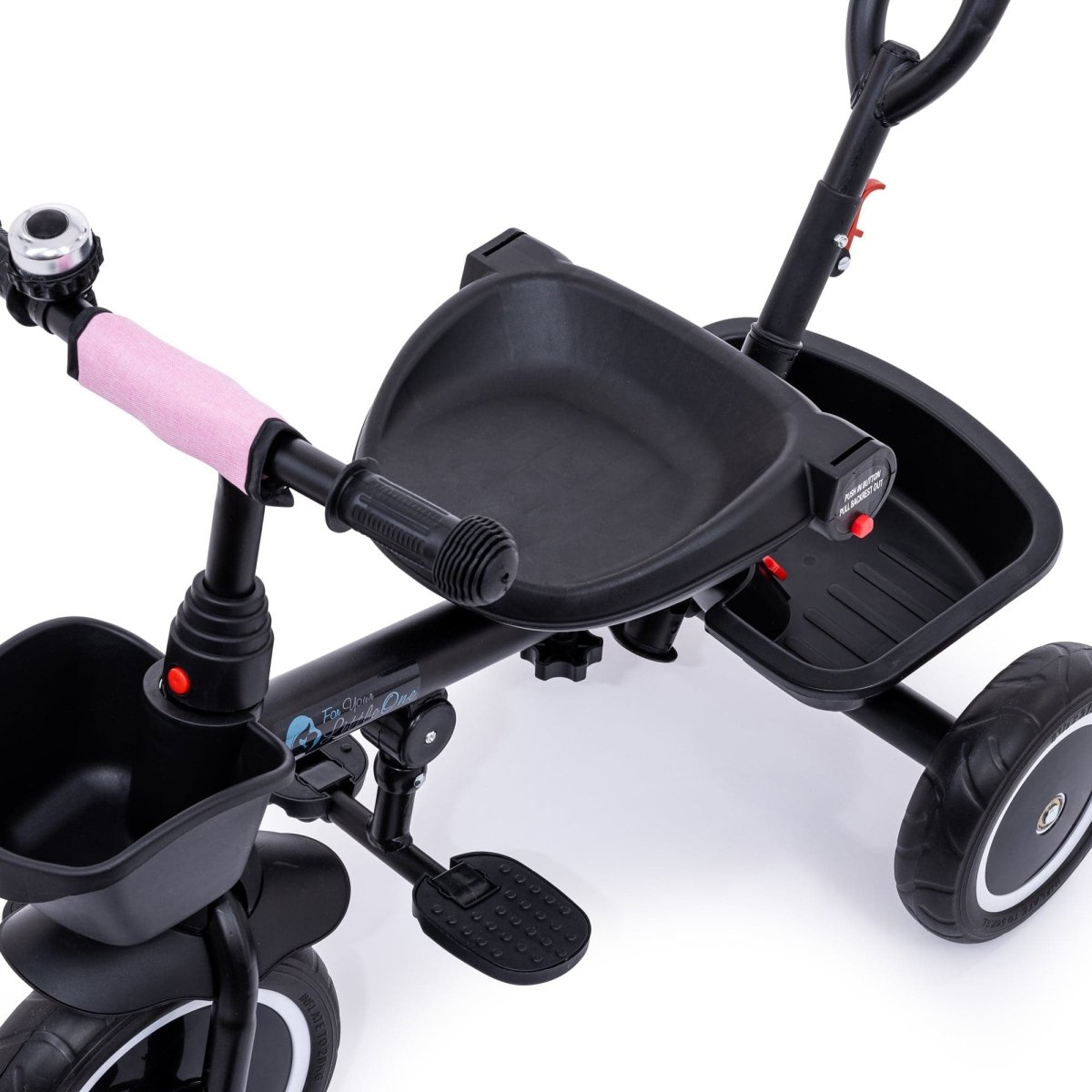 Close-up of a black children's tricycle with pink handlebar on a white background