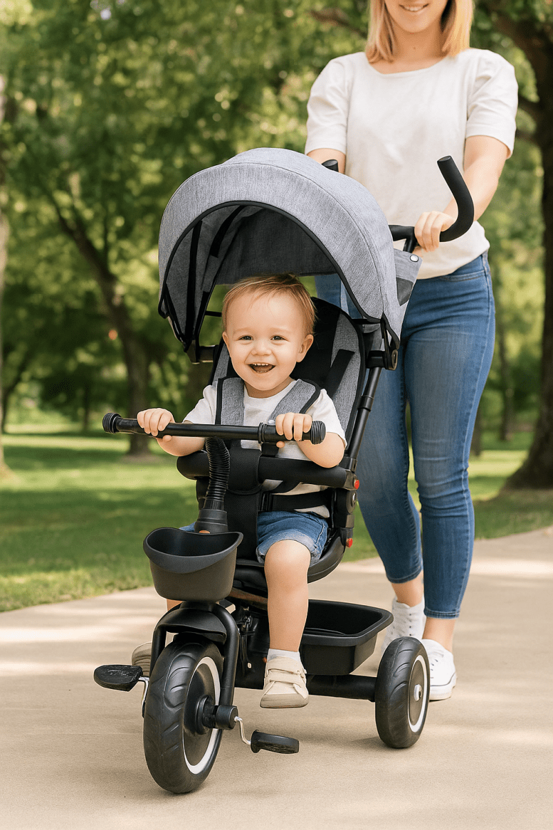 Woman pushing a child in a stroller with a tricycle attachment in a park.