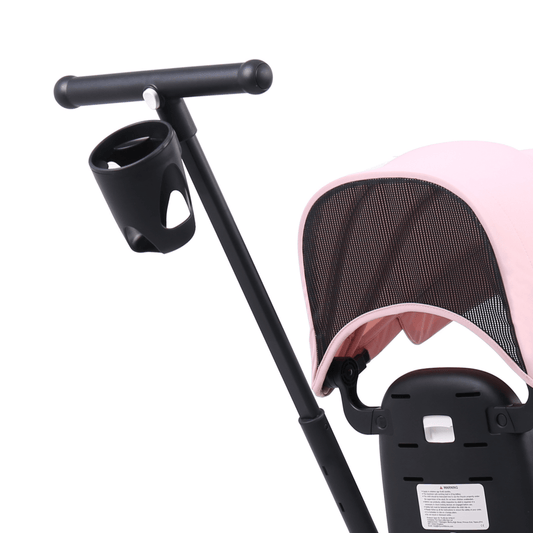 Black cup holder attached to a pink baby stroller on a white background