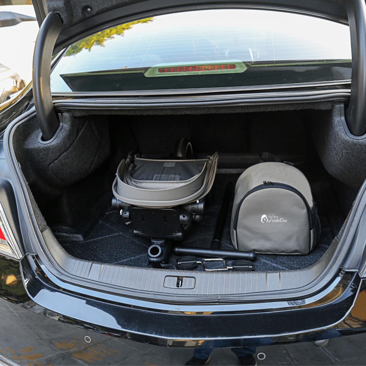 Car trunk with pet gear and a bag inside