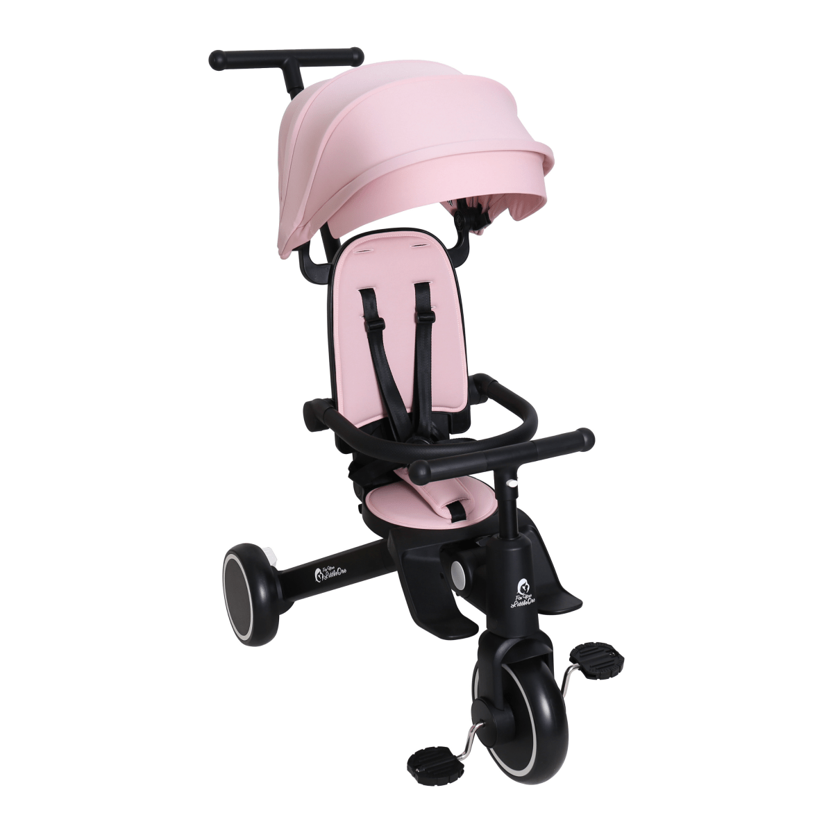 Pink and black child's tricycle with a helmet on a white background
