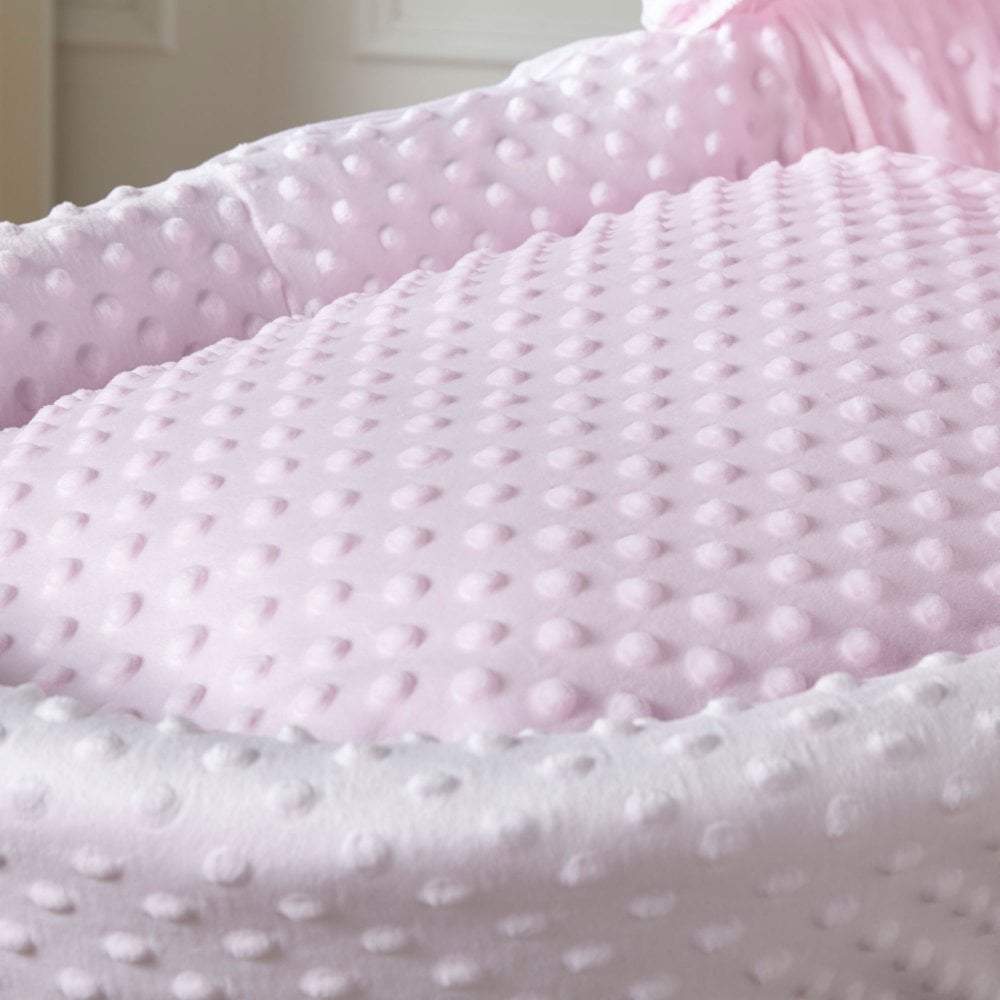 Close-up of pink textured fabric with a soft, plush texture.