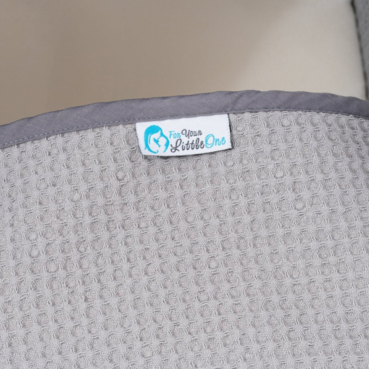 Gray textured surface with a label reading 'For Your Little One' on a beige background